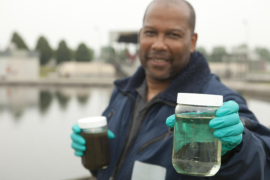 Environmentalist at sewage treatment plant Photograph by BartCo