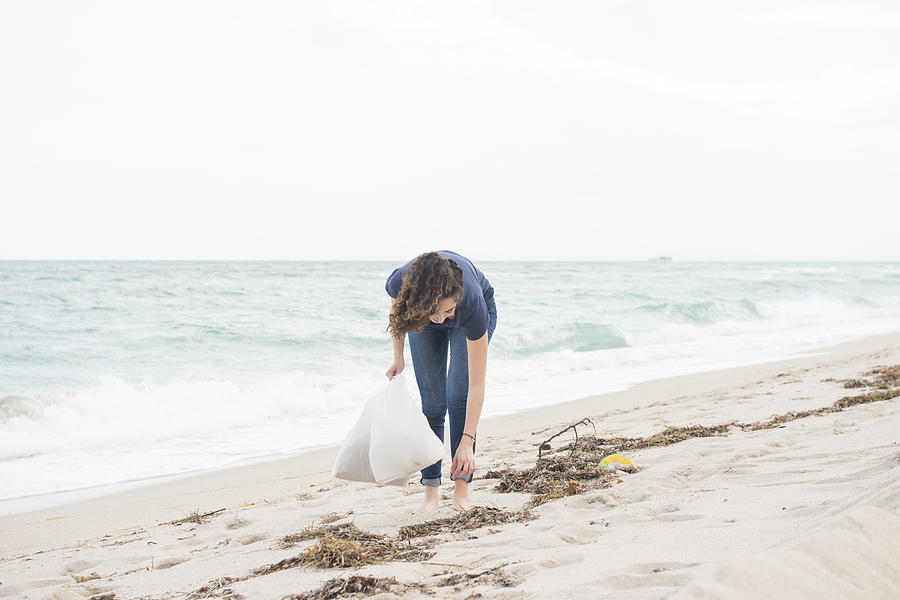 Environmentally Conscious Millennial Woman Cleans Up Beach Miami Florida Photograph by Boogich