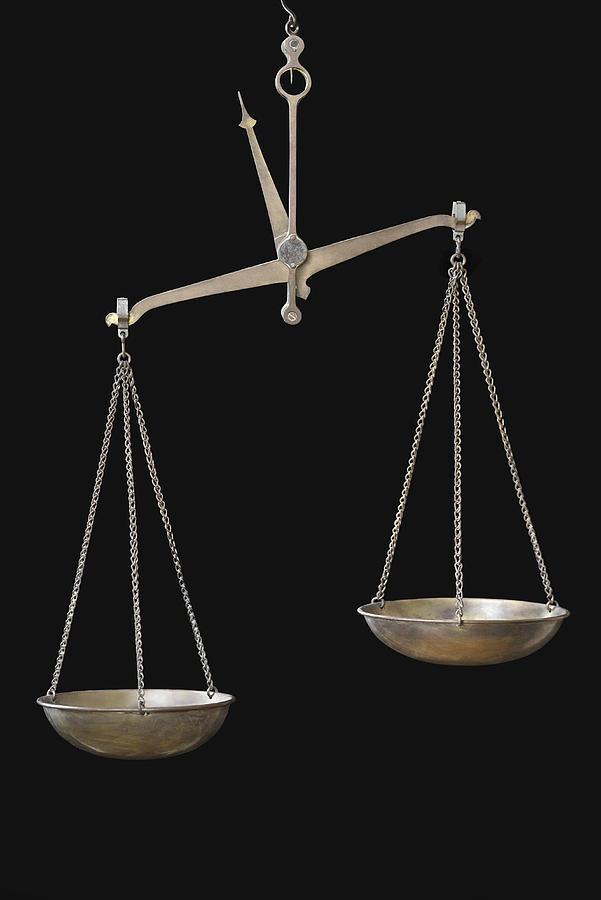 Equal-arm balance hanging against black background Photograph by Vladimir Godnik
