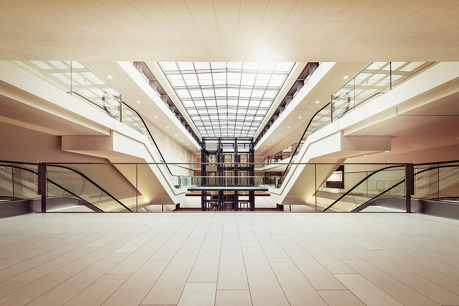 Escalators in a clean modern shopping mall Photograph by PPAMPicture