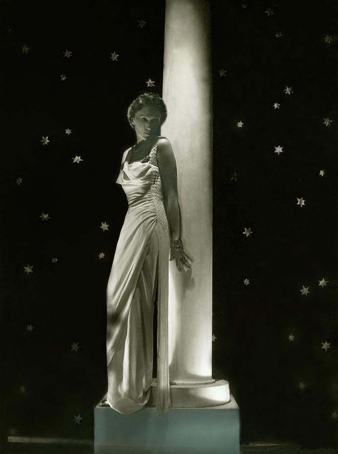 Evelyne Greig Standing By A Pillar Photograph by Horst P. Horst