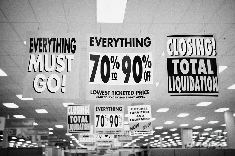 Sign Photograph - everything must go total liquidation closing signs in a store in Saskatoon saskatchewan canada by Joe Fox