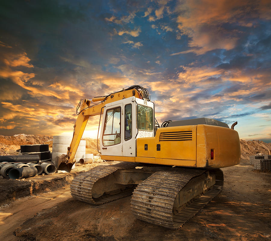 Excavator on a construction site Photograph by Avalon_Studio