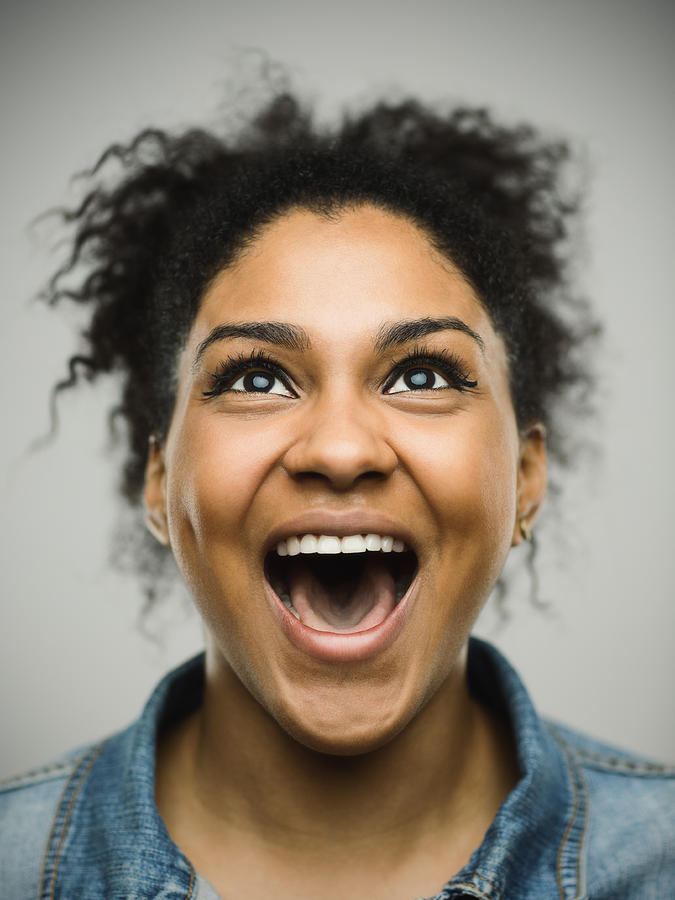 Excited afro american woman shouting against gray background Photograph by SensorSpot