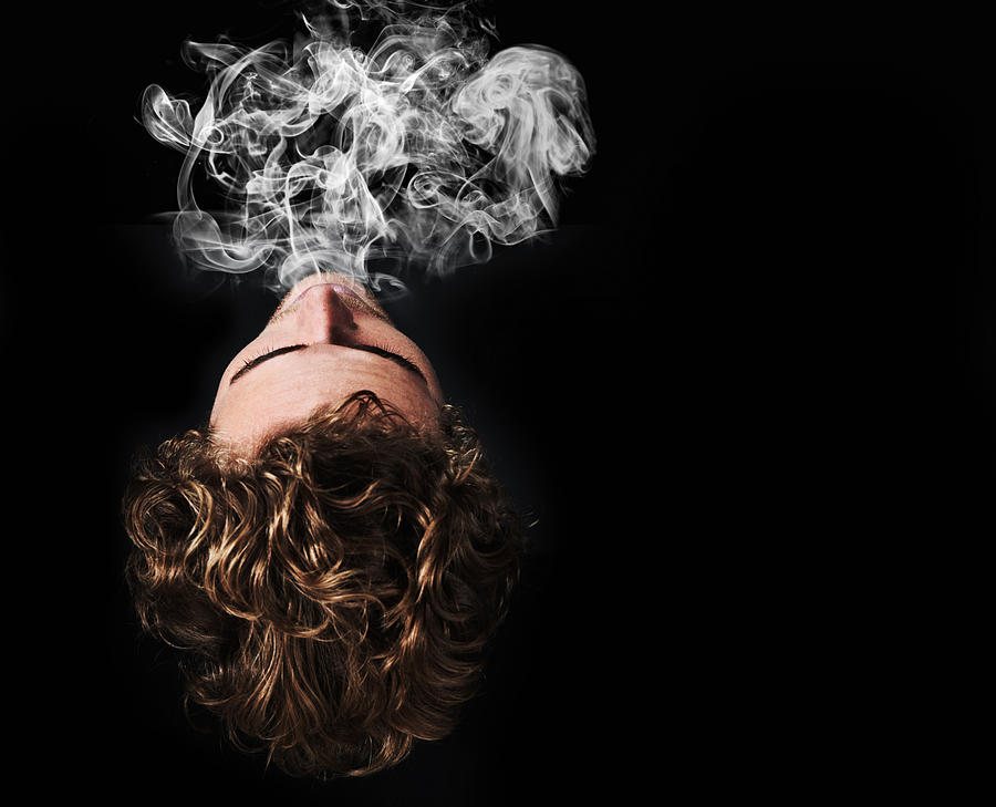 Exhaling the smoke Photograph by PeopleImages