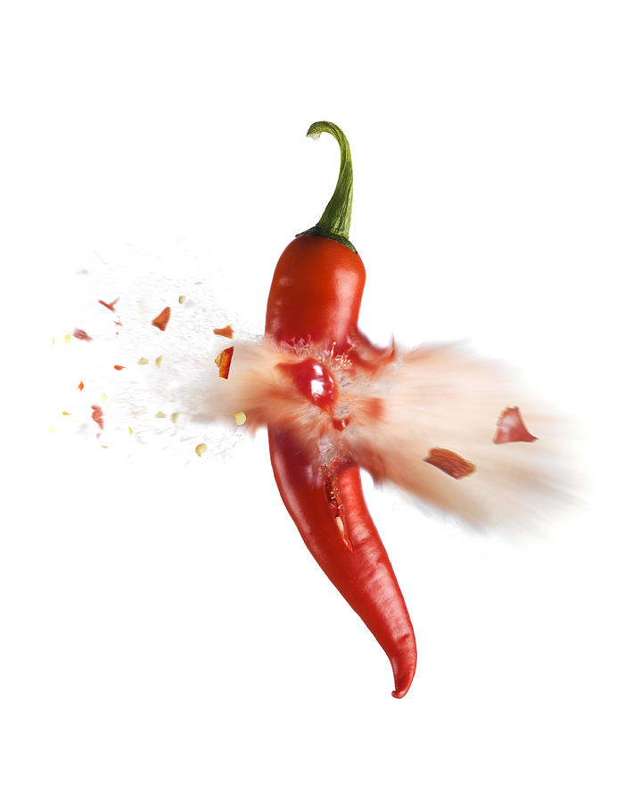 Exploding red chilli pepper Photograph by Jonathan Knowles