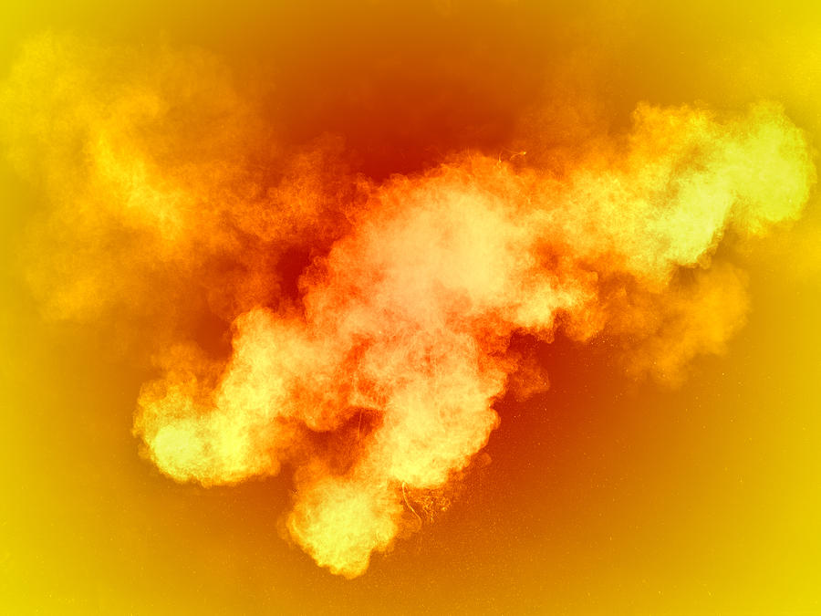 Explosion of a cloud of powder of particles of  colors yellow and orange on a orange background Photograph by Jose A. Bernat Bacete