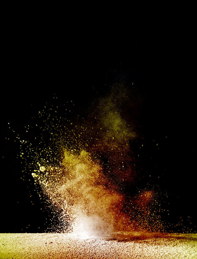 Explosion of a cloud of powder of particles of orange color on a black background Photograph by Jose A. Bernat Bacete