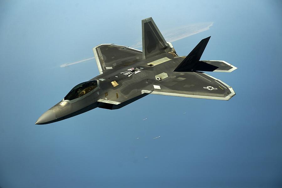 Airplane Photograph - F-22 Raptor Flies over Arabian Gulf  by JC Findley
