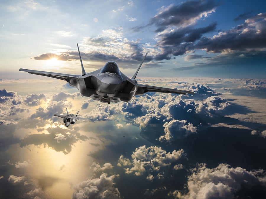 F-35 Fighter Jets flying over the clouds at sunset Photograph by Guvendemir