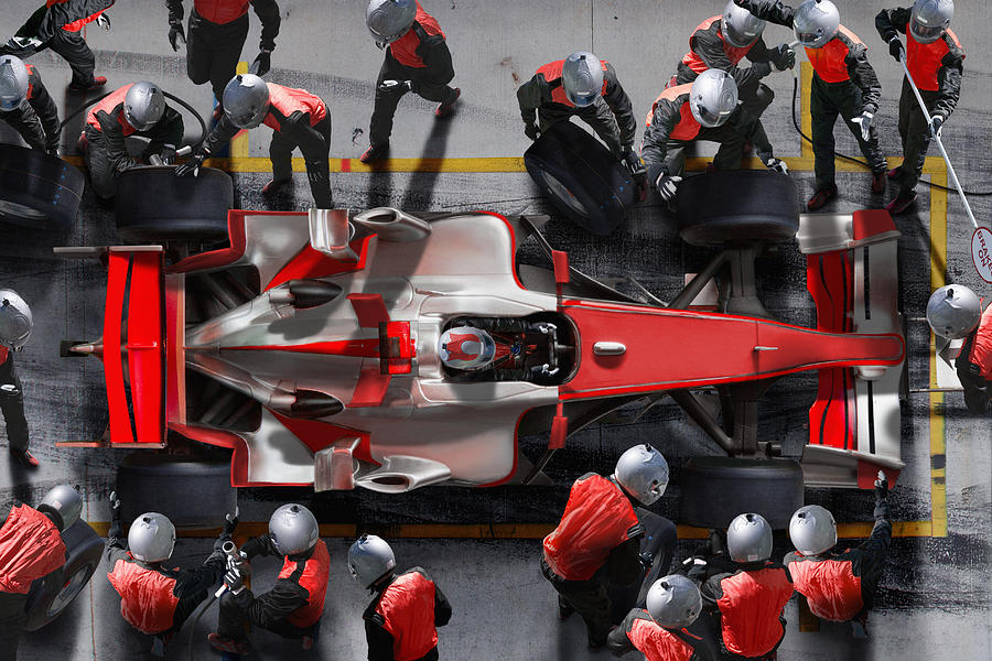 F1 pit crew working on F1 car. Photograph by Jon Feingersh