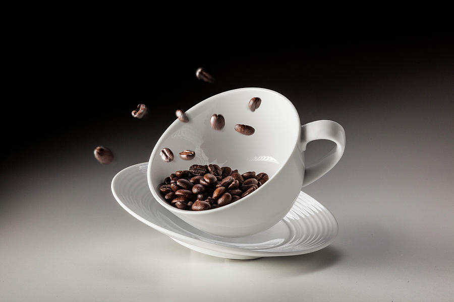 Falling Coffee Cup With Coffee Beans Photograph by Bjorn Holland