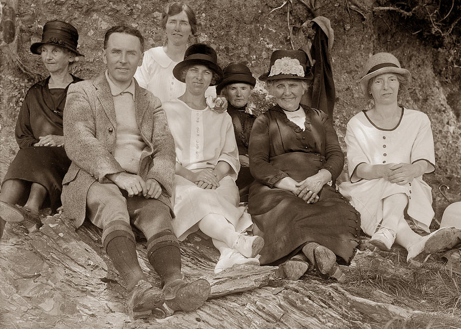 Family group sitting on the ground  Photograph by Photographer unknown