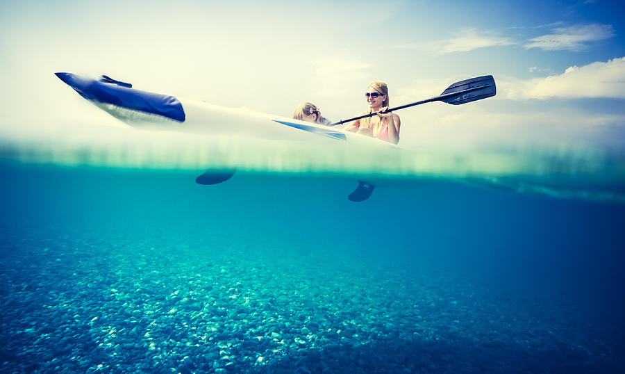 Family kayaking on sea with underwater view Photograph by IvanJekic