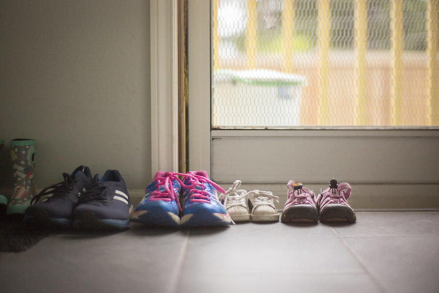 Family of shoes of different sizes sitting near home door Photograph by William Andrew