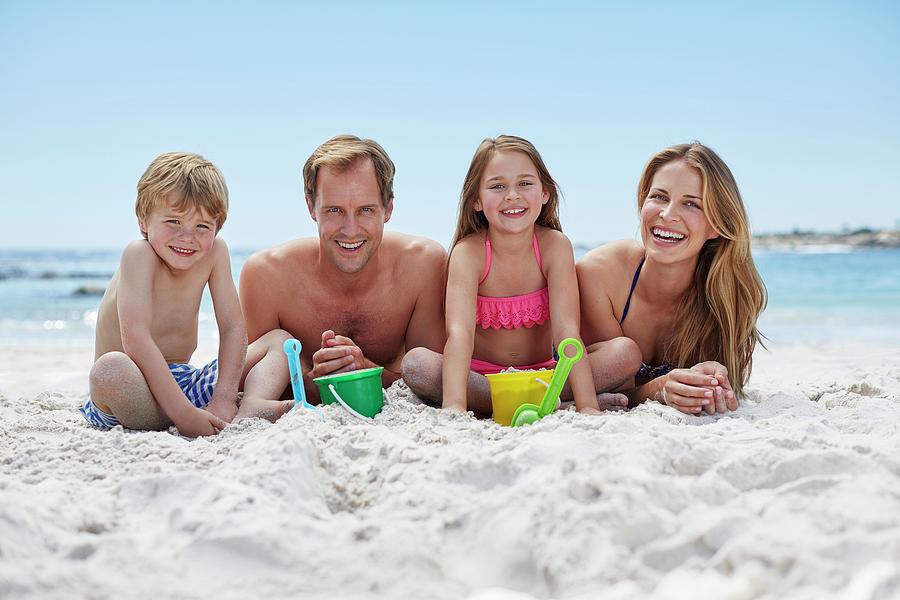 Family On The Beach Photograph by Science Photo Library