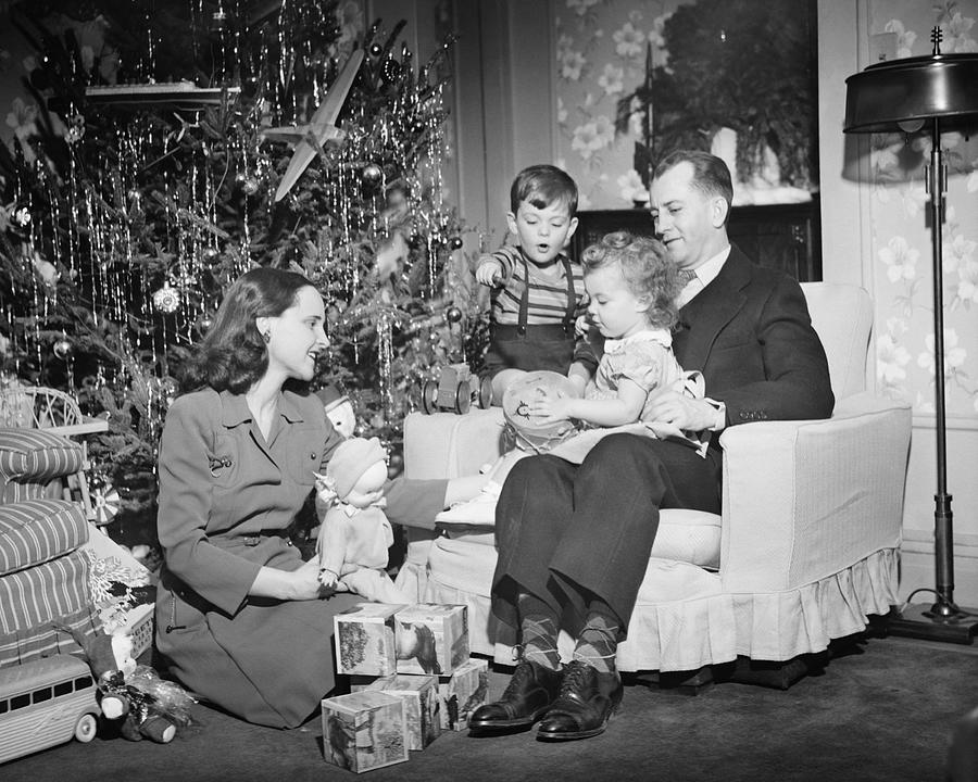 Family opening Christmas presents, children (2-3) (4-5), (B&W) Photograph by George Marks