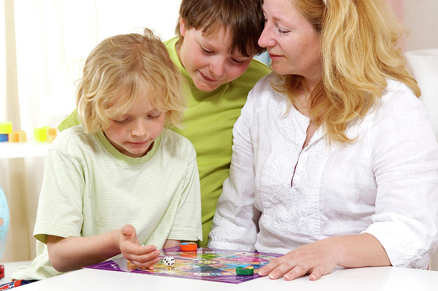 Family Playing Board Game Photograph by Lea Paterson/science Photo Library