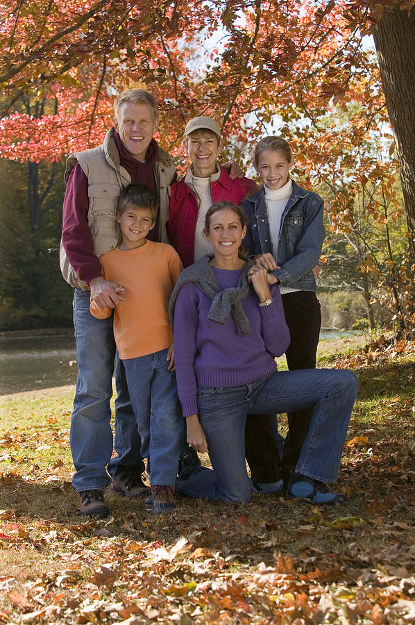 Family portrait in fall foliage Photograph by Comstock Images