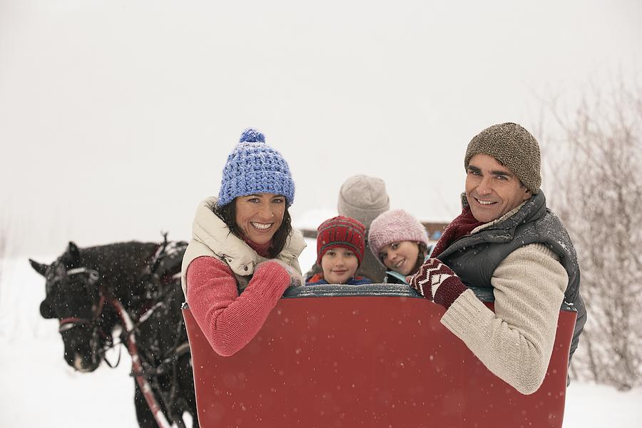 Family riding in horse drawn sleigh Photograph by FangXiaNuo