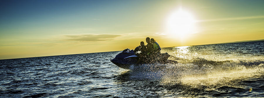 Family Riding  Jet Boat at Sunset Photograph by Vm