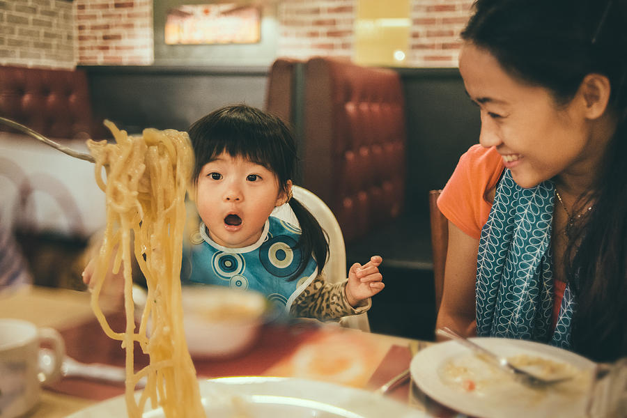 Family sharing spaghetti in a restaurant Photograph by images by Tang Ming Tung