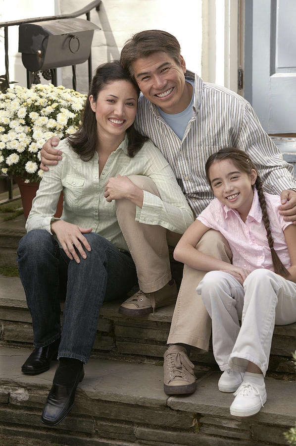 Family sitting outdoor Photograph by Comstock Images