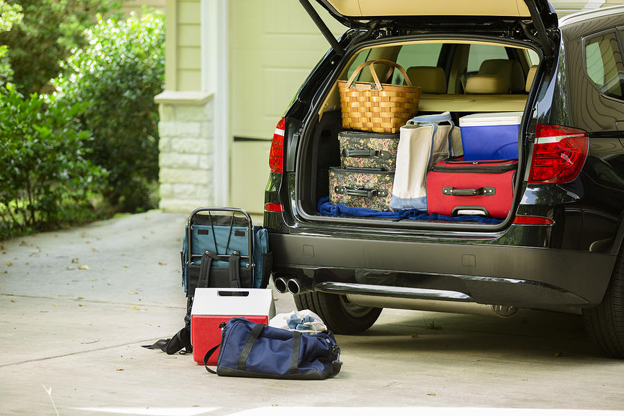 Family vehicle packed, ready for road trip, vacation outside home. Photograph by Fstop123