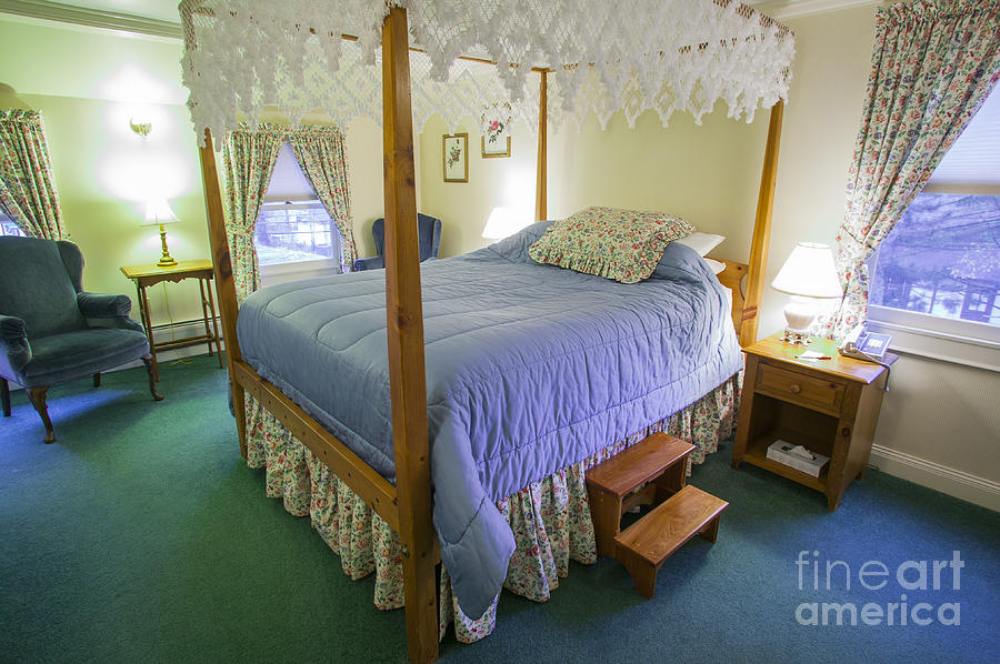 Fancy canopy bed in a cozy hotel bedroom. Photograph by Don Landwehrle