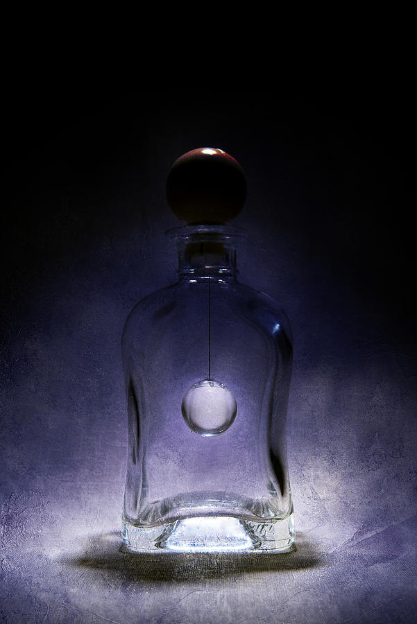 Fancy shaped glass bottle with crystal ball inside Photograph by Jaroslaw Blaminsky