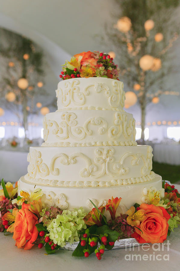 Fancy wedding cake inside a large event tent. Photograph by Don Landwehrle