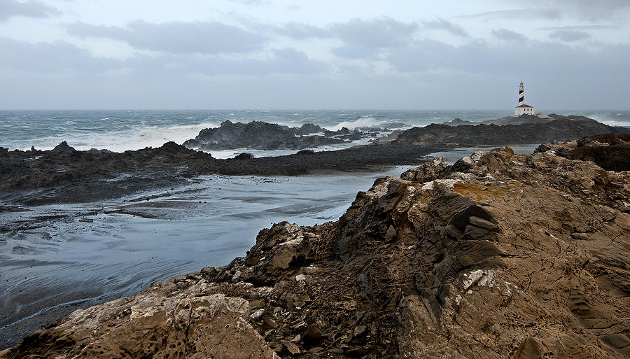 Nature Photograph - A tempest in Minorca north shore - Far far lighthouse in white sea #1 by Pedro Cardona Llambias