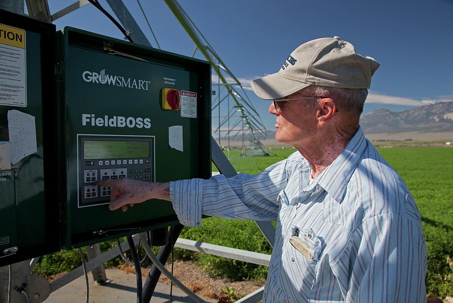Farmer Adjusting Irrigation Controls Photograph by Jim West