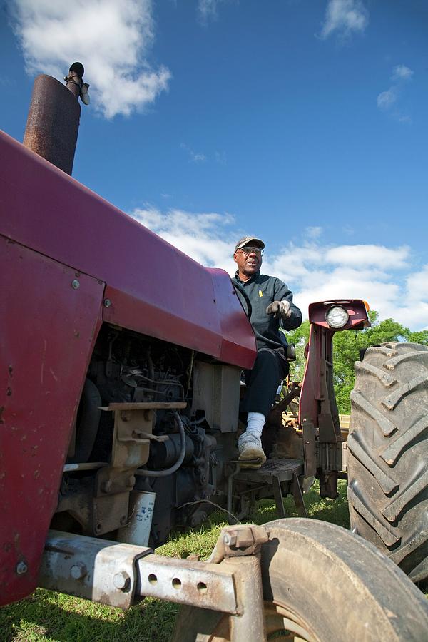 Farm Photograph - Farmer On A Tractor by Jim West