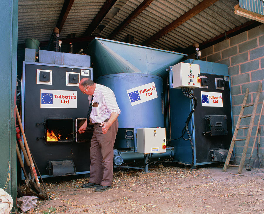 Farmer Tending Wood Chip Combustion Plant Photograph by Martin Bond/science Photo Library