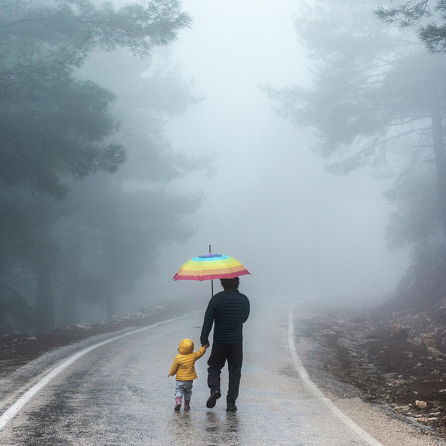 Father And Daughter Walking Away Into A Photograph by Ozgur Donmaz
