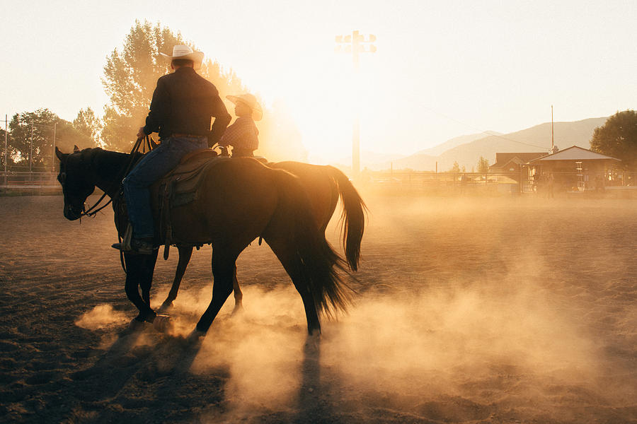 Father and son at rodeo arena Photograph by Ferrantraite