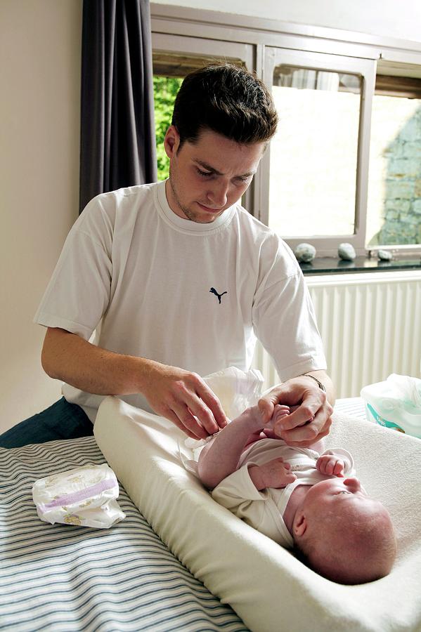 father-changing-his-baby-s-nappy-photograph-by-claire-deprez-reporters