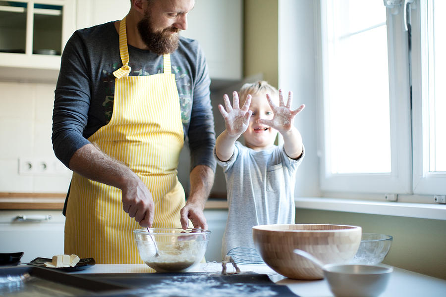 Father cooking with his son Photograph by Yulkapopkova