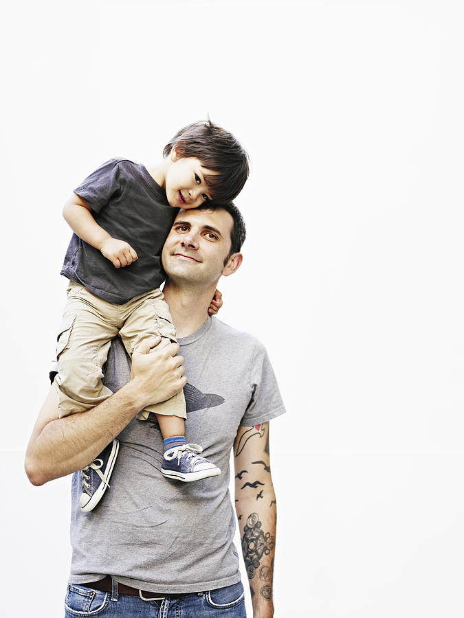 Father holding son on shoulder Photograph by Thomas Barwick