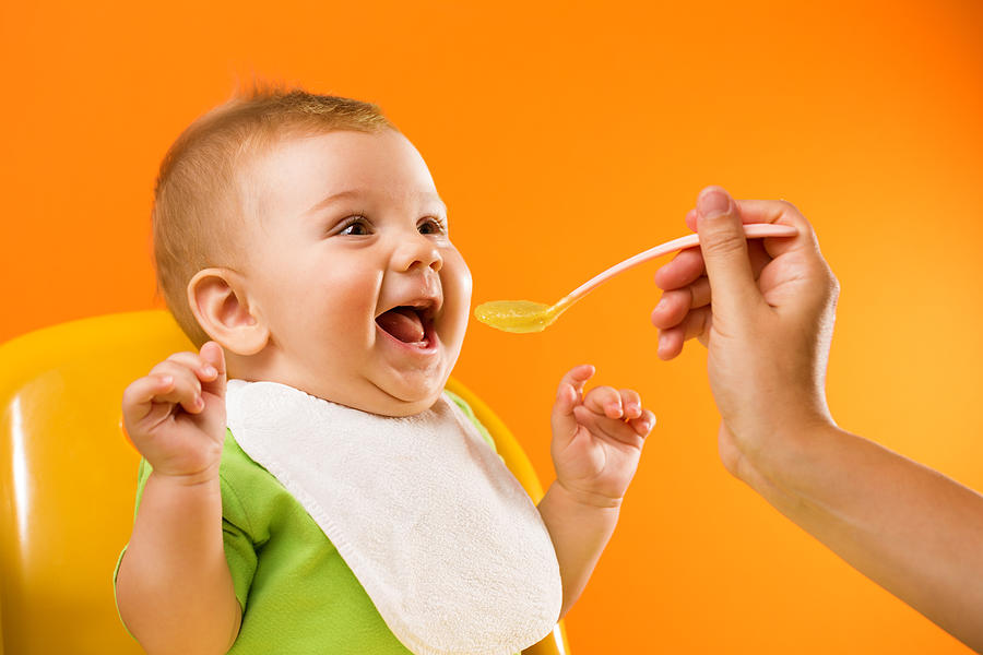 Feeding excited baby Photograph by Dimitris66