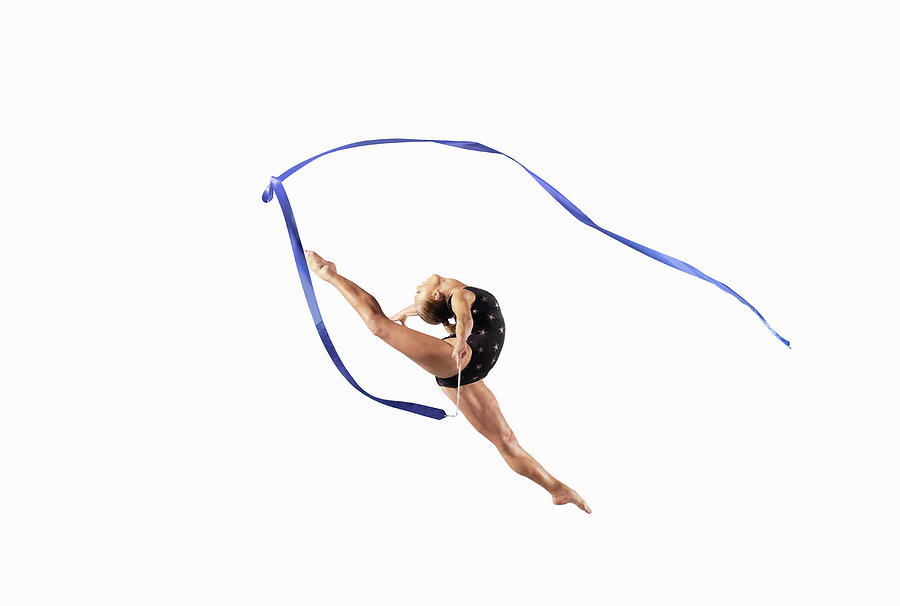 Female Athlete Jumping Gracefully Mid Air With a Ribbon Photograph by 10000 Hours