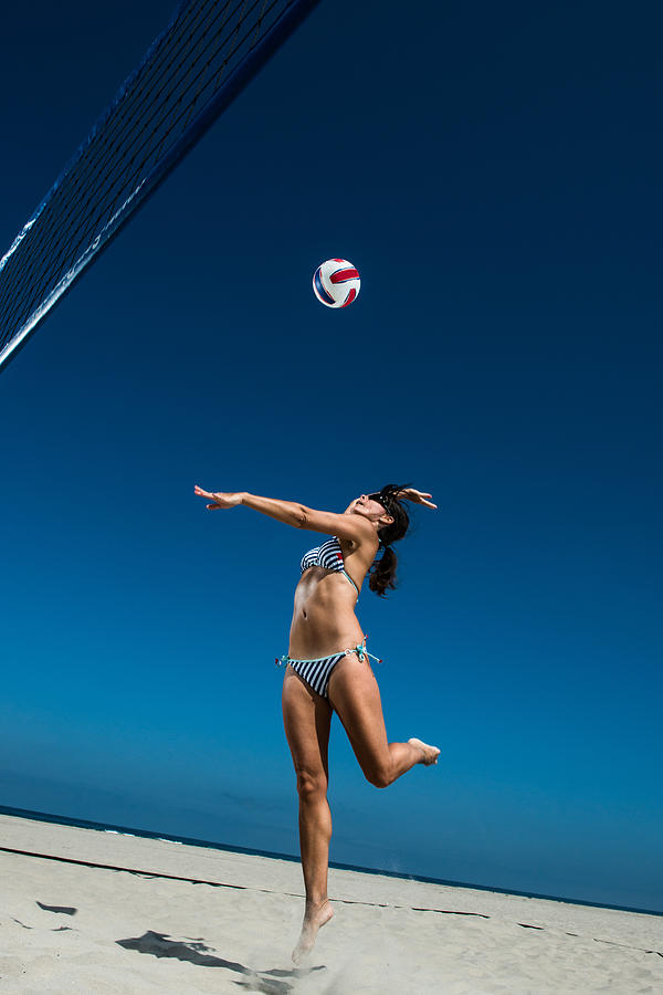 Female beach volleyball player hitting ball Photograph by Corey Jenkins