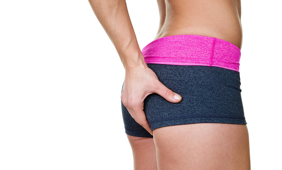 Female buttocks wearing workout clothing Photograph by John Sommer