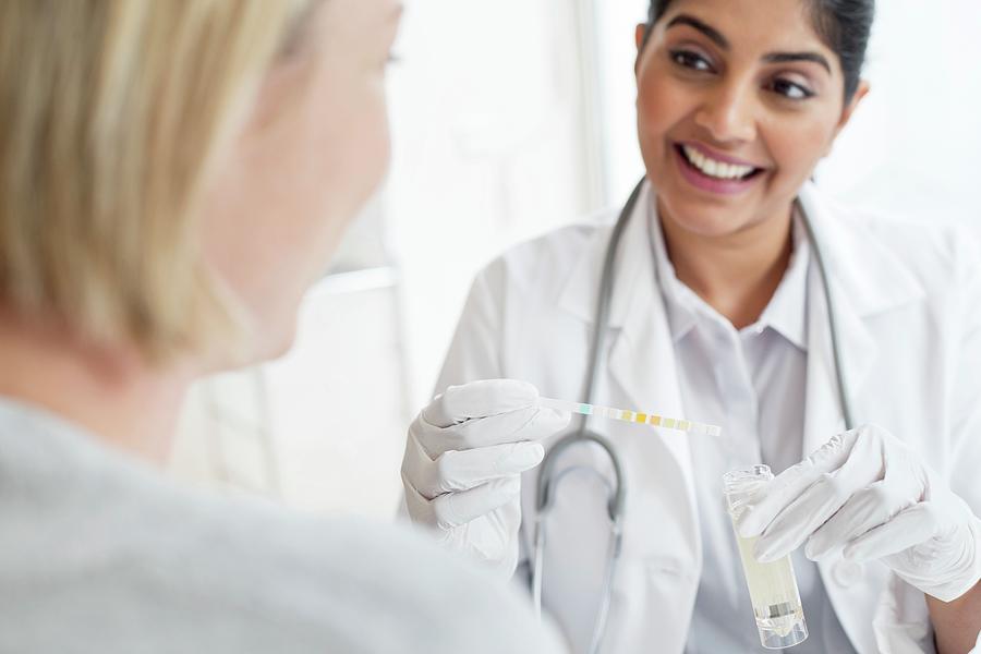 Female Doctor Testing Patient's Urine by Science Photo Library