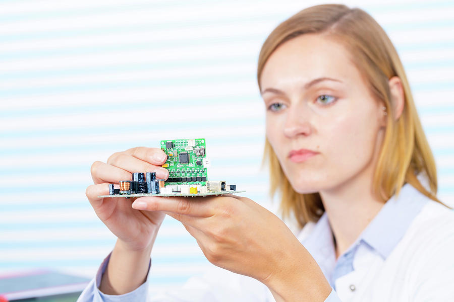 Female Electrical Engineer Fixing Circuit Photograph by Wladimir Bulgar/science Photo Library