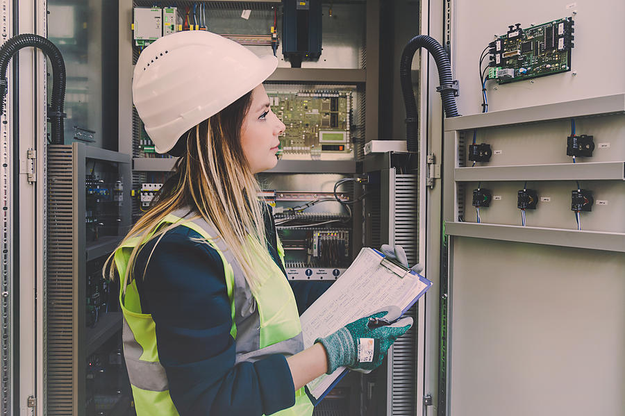 Female Energy Station Electrician Engineer Working at Energy Control Room Photograph by Serts