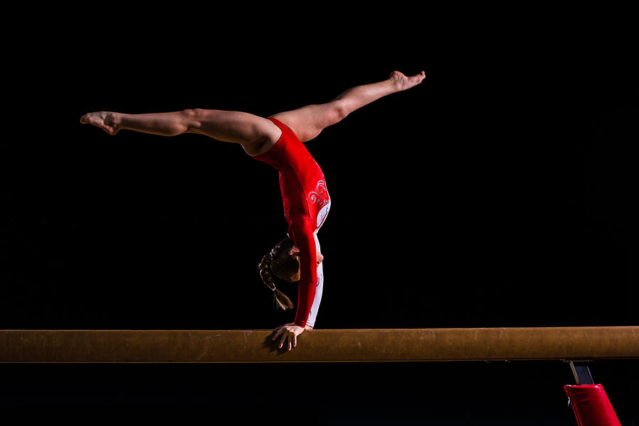 Female gymnast in sports hall Photograph by Simonkr