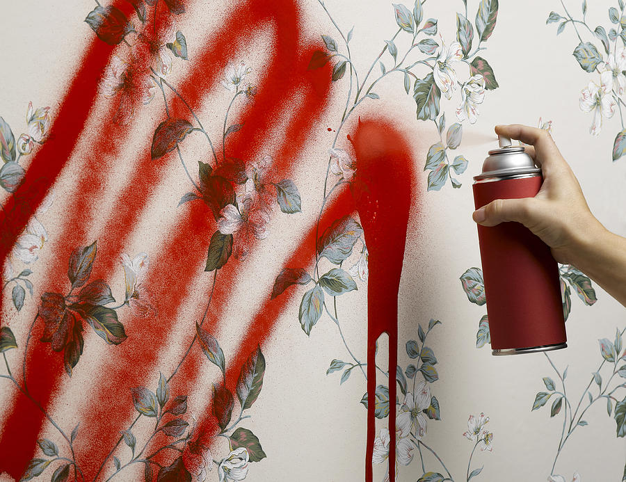 Female hand spray painting wallpaper Photograph by Jeffrey Coolidge