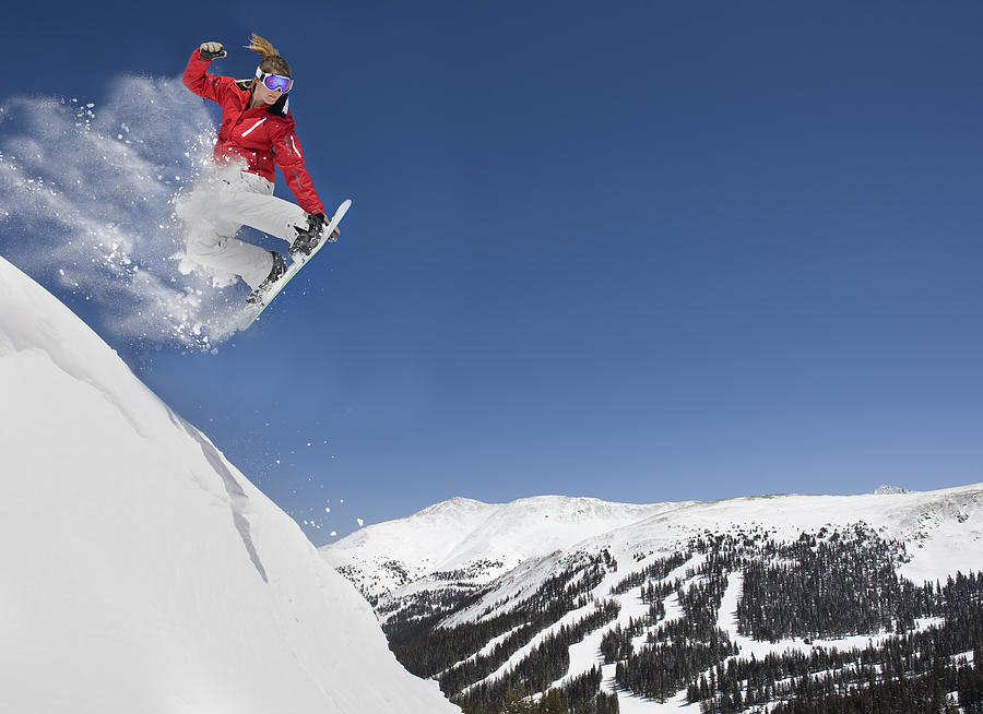 Female Making Extreme Snowboard Jump Photograph by Sportstock